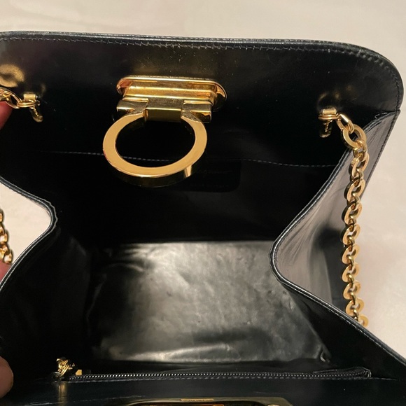 Authentic Salvatore Ferragamo black leather bag with shiny gold metal handle. - Picture 10 of 11
